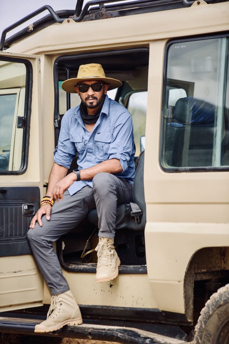 Me sitting in the open door of a safari vehicle in a wide hat and sunglasses