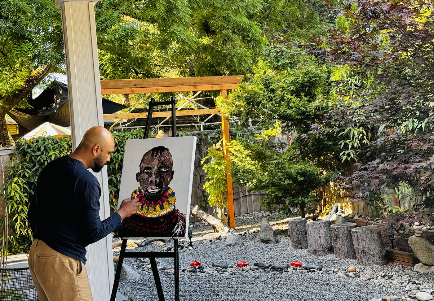 Me painting the portrait at an easel in my garden